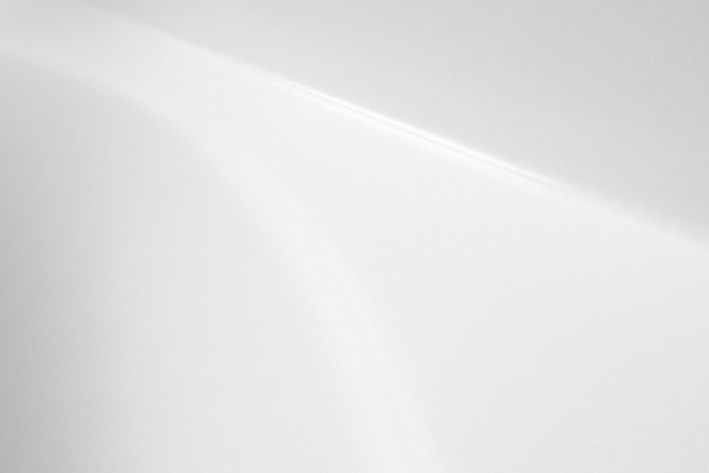 white neutral background with faint light streak running across.