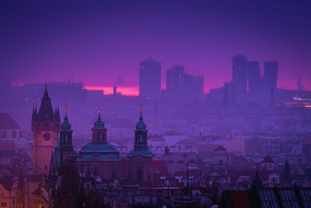 Skyline of european city with a purple color edit as the sun is setting.